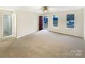 Spacious living room with neutral walls and carpet, open layout, and lots of sunlight at 1313 Ridgewood Dr, Concord, NC 28027