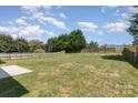 Large backyard with lawn, a privacy fence, and mature trees at 1615 Jekyll Ln, Waxhaw, NC 28173