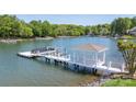 Picturesque dock with a boat lift and covered area, providing direct access to the serene lake waters at 19528 Mary Ardrey Cir, Cornelius, NC 28031