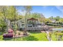 Beautiful backyard with multi-tiered deck, stone fireplace, and swimming pool, perfect for outdoor living at 19528 Mary Ardrey Cir, Cornelius, NC 28031