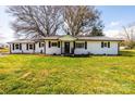 Charming single-story home featuring a well-manicured lawn and freshly painted exterior at 1993 Moss Farm Rd, Hickory, NC 28602