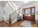 Bright foyer with hardwood floors, staircase, and a wood-framed front door with glass panels at 20637 Island Forest Dr, Cornelius, NC 28031