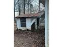 Exterior view of a dilapidated shed with a rusty roof, set amidst fallen leaves at 2124 Shoal Rd, Lincolnton, NC 28092