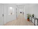 Bright hallway with light wood floors, a built-in niche, and views into the living area at 218 Alenda Lux Cir, Mooresville, NC 28115