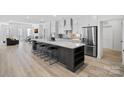 Open kitchen featuring an island with bar seating, stainless steel appliances, and ample counter space at 218 Alenda Lux Cir, Mooresville, NC 28115