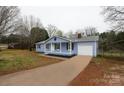Charming single-story house with light blue exterior, a concrete driveway, and well-maintained landscaping at 2225 Grace Church Rd, Salisbury, NC 28147