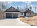 A charming single-story home with a stone and gray shingle accent and a two car garage at 24 Eastwinds Dr, Hickory, NC 28601