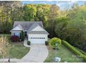 A lovely home featuring mature trees, a well-manicured lawn, and a two-car garage at 3052 Santee Ct, Indian Land, SC 29707