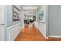 Inviting foyer featuring beautiful hardwood floors, decorative wall trim, and arched entryways at 3052 Santee Ct, Indian Land, SC 29707