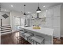 Bright kitchen boasts a large island with seating, stainless steel appliances, and modern pendant lighting at 3655 Vallette Ct, Charlotte, NC 28203