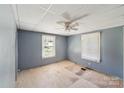Spacious bedroom with two windows offering natural light and wood flooring needing repair at 405 Link St, Fort Mill, SC 29715