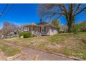 Charming one-story home with a cozy front porch and mature trees, offering great curb appeal at 405 Link St, Fort Mill, SC 29715