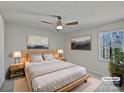 Neutral main bedroom featuring a modern bed frame, ceiling fan, and a bright window at 426 W Ballard St, Cherryville, NC 28021