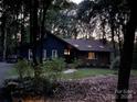 Two-story single-Gathering house with mature trees, a brick foundation, and a long driveway at 5434 Beckhaven Ln, Charlotte, NC 28216