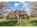 Charming brick home featuring a well-manicured lawn and mature landscaping at 6000 Embassy Ct, Wesley Chapel, NC 28110