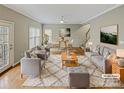 Staged living room with modern decor, hardwood floors, and plenty of natural light at 670 Sherwood Pl, Mooresville, NC 28115