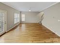Spacious living room featuring hardwood floors, a ceiling fan, and a door to the deck at 670 Sherwood Pl, Mooresville, NC 28115