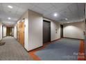 Well-lit hallway with neutral walls, carpeted floor, and elevator access, offering a clean and functional space at 715 N Church St # 503, Charlotte, NC 28202