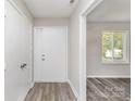 Bright foyer with neutral walls, wood-look flooring, and a large window at 7212 Hackberry Ln, Charlotte, NC 28226