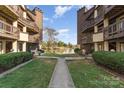 Exterior view of two buildings separated by a walkway looking out to a lake at 8175 Cedar Glen Dr, Charlotte, NC 28212