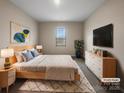 Cozy staged bedroom with neutral tones, a comfortable bed, and modern furnishings creating a relaxing retreat at 8212 Merryvale Ln, Charlotte, NC 28214