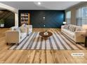 Bright, virtually staged living room with modern decor, stylish furniture, and hardwood flooring for a contemporary feel at 8212 Merryvale Ln, Charlotte, NC 28214