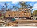 View of the new home construction with lumber and brick base on a clear day at 914 Saluda St, Rock Hill, SC 29730