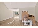 Spacious unfinished living room with vaulted ceiling, wood flooring, and French doors at 914 Saluda St, Rock Hill, SC 29730