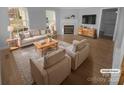 Bright living room features a cozy fireplace, hardwood floors, and comfortable furnishings for relaxing at 9144 Cameron Wood Dr, Charlotte, NC 28210