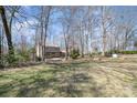 Expansive backyard perfect for outdoor activities and relaxation under a canopy of trees at 107 Grand Canyon Rd, Stanley, NC 28164