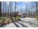 Spacious driveway leading to a two-car garage, surrounded by lush greenery at 107 Grand Canyon Rd, Stanley, NC 28164