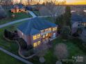 Breathtaking aerial view of the brick home with balcony, manicured lawn and lush greenery at 110 49Th Avenue Nw Pl, Hickory, NC 28601