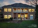 Spacious home with a large balcony, manicured lawn, outdoor patio, and serene backyard setting at 110 49Th Avenue Nw Pl, Hickory, NC 28601