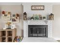 Inviting living room showcasing a decorative white brick fireplace and stylish mantle decor at 1448 Morrocroft Trl, Gastonia, NC 28054