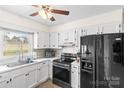 Functional kitchen features white cabinets, stainless steel appliances, and ample counter space at 1448 Morrocroft Trl, Gastonia, NC 28054