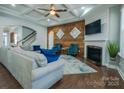 Cozy living room features a fireplace, stylish wood accent wall, and coffered ceiling at 15125 Skypark Dr, Huntersville, NC 28078