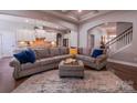 Open-concept living room showcasing a large sectional sofa, neutral decor, and seamless flow to the kitchen at 15125 Skypark Dr, Huntersville, NC 28078