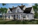 Charming two-story home with a welcoming front porch, complemented by meticulous landscaping at 155 Eagle Chase Ln, Troutman, NC 28166