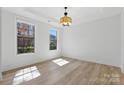 Bright, airy bedroom with large windows and wood flooring, and modern ceiling light at 160 Belfry Loop, Mooresville, NC 28117