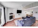 Bright living room features an open floor plan, fireplace, and hardwood floors at 1606 Sharon W Rd, Charlotte, NC 28210