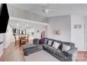 Spacious living room with hardwood floors, couch, and an open concept dining area at 1606 Sharon W Rd, Charlotte, NC 28210