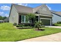 Beautifully landscaped home with brick accents and a lush green lawn at 1638 Sweetmoss Loop, Denver, NC 28037