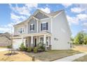 Beautiful home featuring well maintained lawn and a welcoming covered front porch at 165 Winterberry St, Mooresville, NC 28117