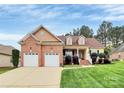 Charming brick and siding home with a well-manicured lawn and an attached two-car garage at 1674 Wakefield Way, Rock Hill, SC 29730