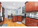 Well-lit kitchen featuring wooden cabinets, stainless steel appliances, granite counters, and breakfast nook at 1674 Wakefield Way, Rock Hill, SC 29730
