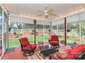 Relaxing screened porch featuring cozy seating, ceiling fan and serene views of the backyard at 1674 Wakefield Way, Rock Hill, SC 29730