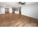 Bright open concept living room showing the floor plan and hardwood style flooring at 174 Hanging Rock Trl # 104, Statesville, NC 28625