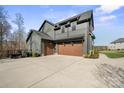 Side view of a modern two-car garage with concrete driveway at 180 Twin Sisters Ln, Mooresville, NC 28117