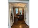 Elegant dining room with hardwood floors, chandelier, and large windows at 203 S Washington St, Monroe, NC 28112