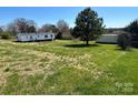 Expansive backyard with lush green grass and mature trees, offering plenty of open space at 24257 Austin Rd, Albemarle, NC 28001